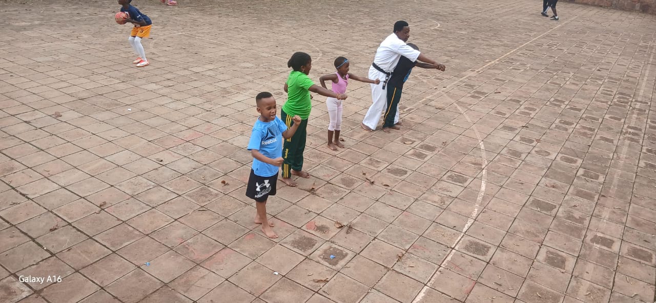 Children practicing karate with their instructor