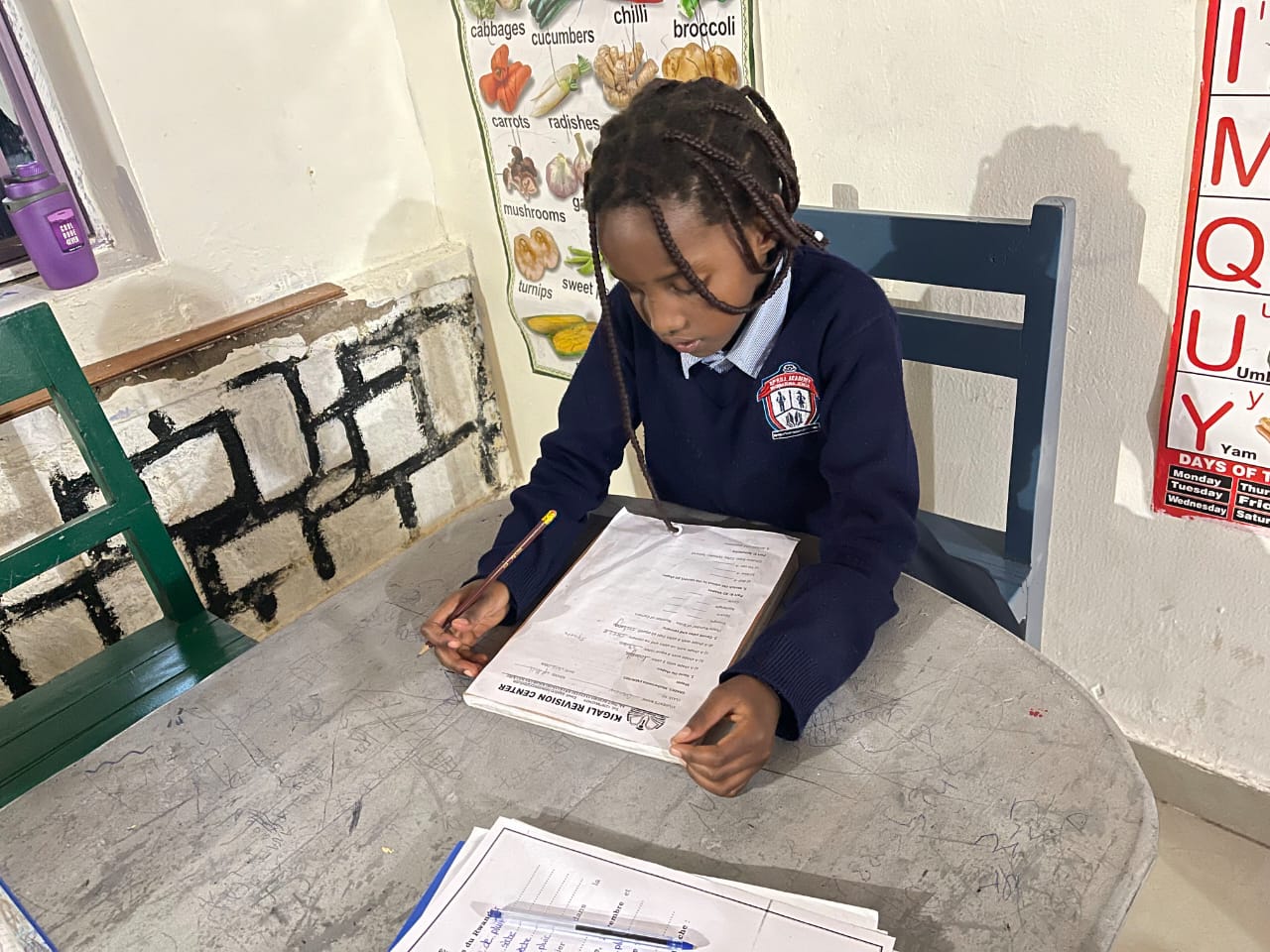 Student studying with Kigali Revision Center materials